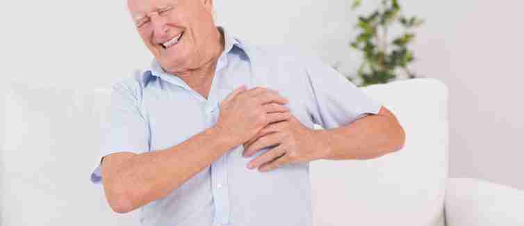 Old man clutching his chest in pain