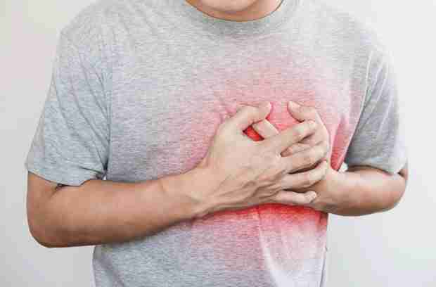 Man clutching chest from heart attack from too much bulletproof coffee