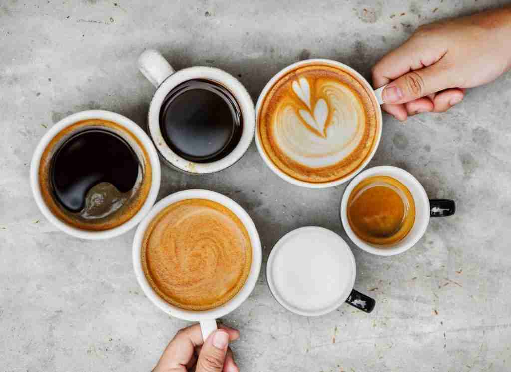 Americano, Latte, Black Coffee, Flat White, espresso on a table next to each other. 