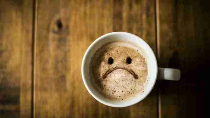 What Kind of Coffee Beans Does Starbucks Use? 12 A brew with some foam on that with a frowny face