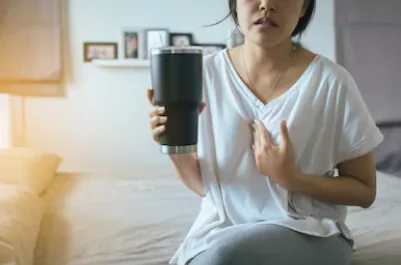 How Much Coffee Is Too Much? 9 girl with acid reflux or digestive issues because of drinking coffee.