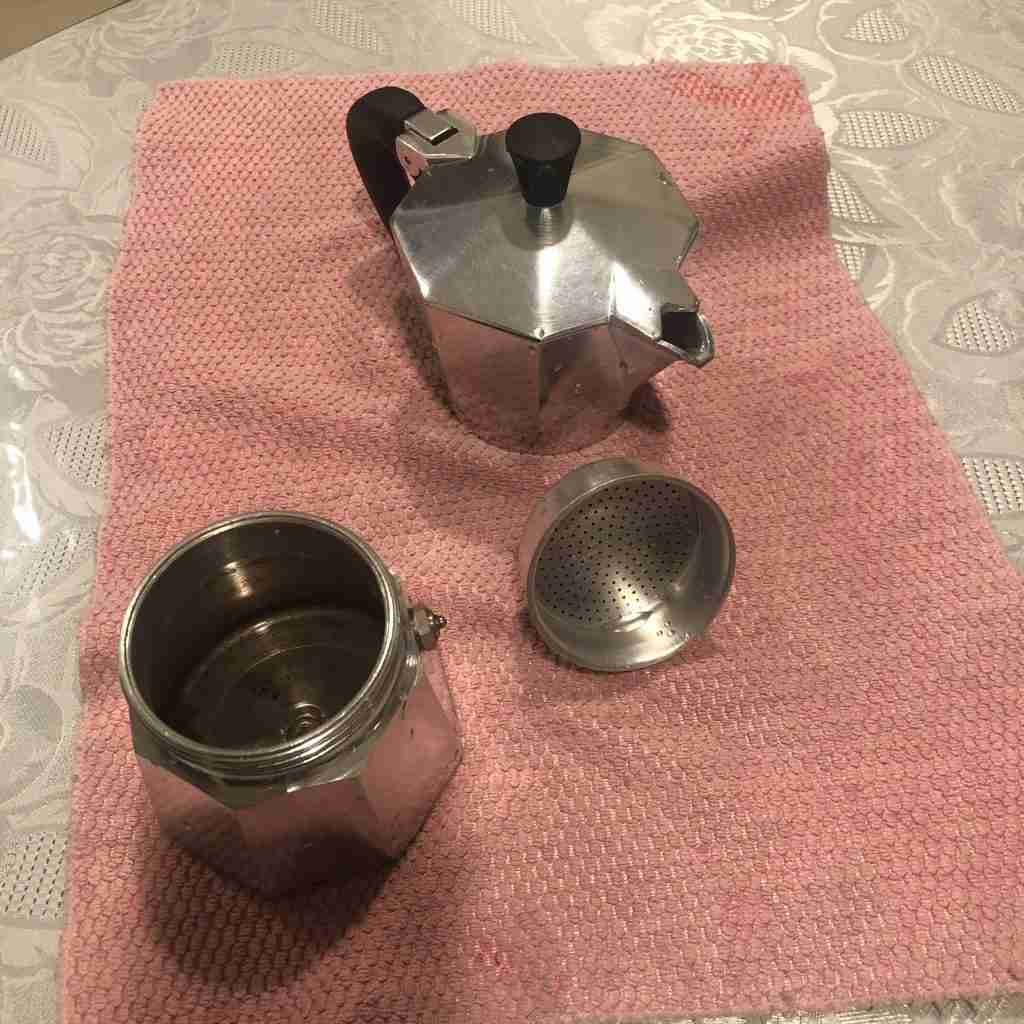 Cleaned moka pot on a pink towel