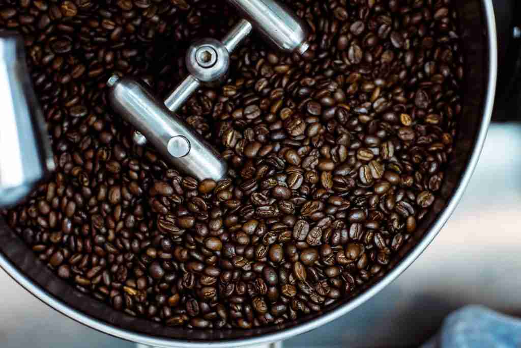 dark roasted coffee beans in an industrial coffee roaster