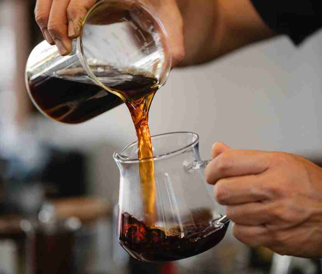 pouring coffee from beaker into glass pot