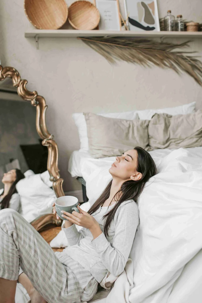 Coffee After Dinner: Is It Bad for You? 8 Woman relaxing against the bed with a cup of coffee
