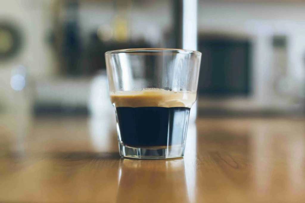 How long does 2 cups of coffee stay in your system 7 Single shot of espresso in a small glass on a wooden counter